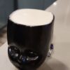 Black Baby Head Cup with beer inside.