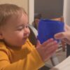 Child kissing a Blue Baby Head Cup