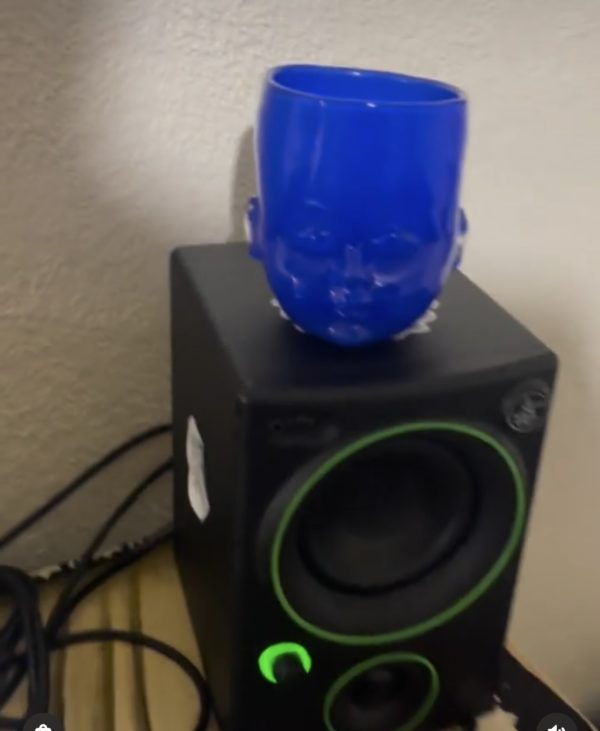 Blue Baby Head Cup on top of a speaker