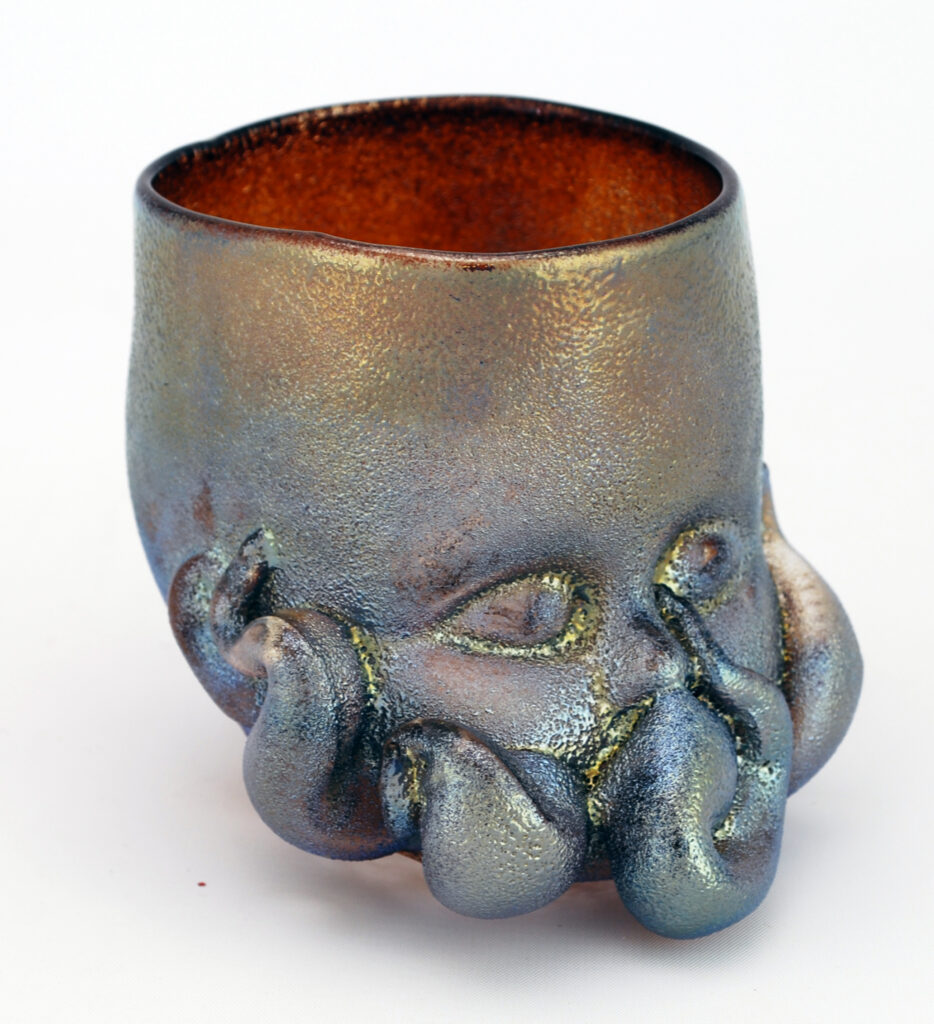 Silvery Green Glass Baby Head Cup doen in the stlye of Cthulhu